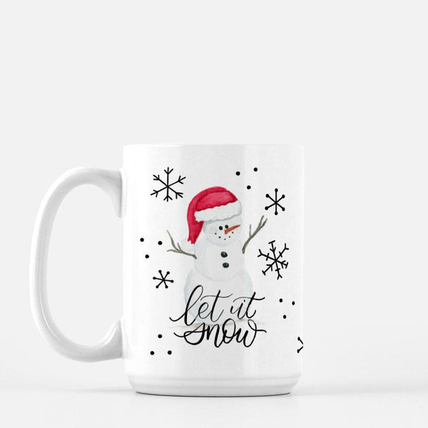 15oz white ceramic mug with watercolor snowman with a red santa hat, snowflake doodles and says let it snow in calligraphy