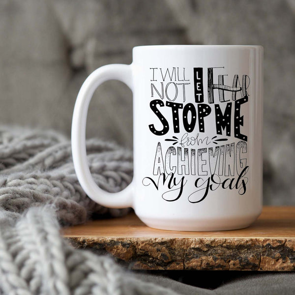 15oz white ceramic mug with hand lettered illustrated design that says I will not let fear stop me from achieving my goals shown on a wooden tray with a grey knit blanket