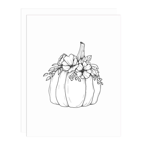 Notecard with an illustration of a pumpkin with floral, berry and leaves arranged on top in black and white