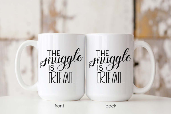 15oz white ceramic mug with hand lettered illustrated design that says the snuggle is real showing the front and back of the mug