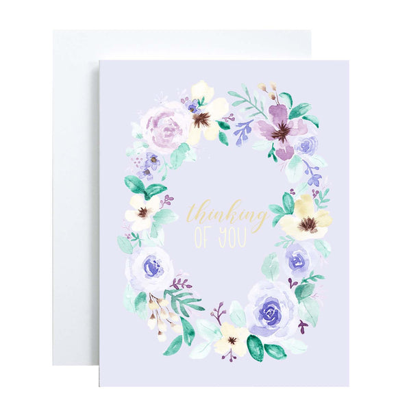 watercolor wild flower wreath on a friendship greeting card that says thinking of you in the center with a white A2 envelope