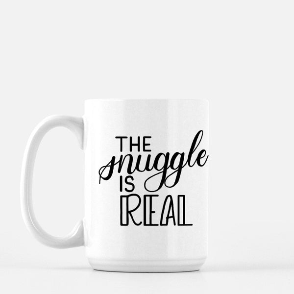 15oz white ceramic mug with hand lettered illustrated design that says the snuggle is real