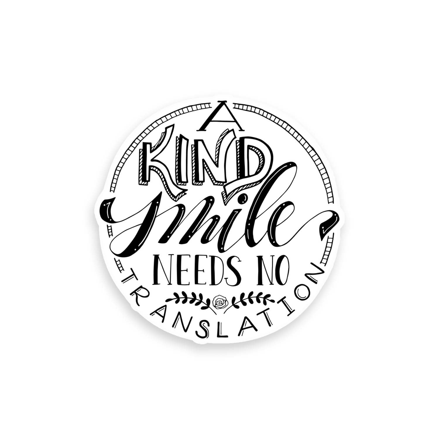 3" hand lettered illustrated vinyl sticker saying a kind smile needs no translation in black and white