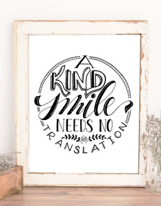 wall art typography design that says A Kind Smile Needs No Translation in black and white