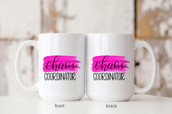 15oz white ceramic mug with hand lettered illustrated design that says chaos coordinator with a pink paint swash showing front and back of the mug