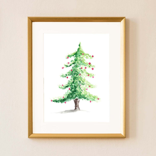 Watercolor woodland Christmas tree with red christmas bulbs shown hanging on the wall in a gold frame