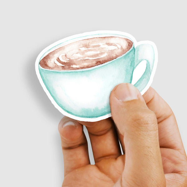 3" vinyl sticker of a watercolor blue coffee mug full of hot coffee shown with a woman's hand holding the sticker