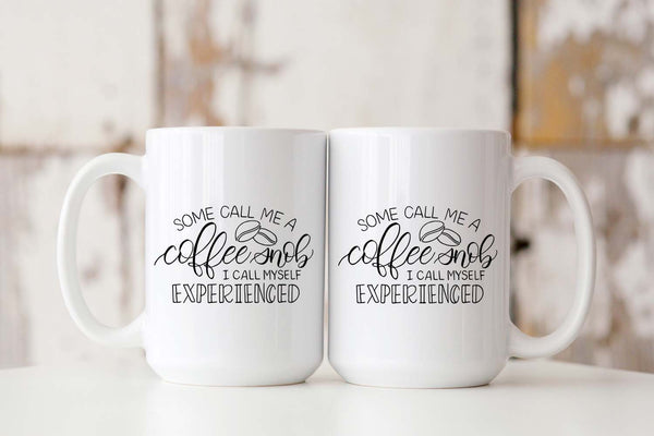 15oz white ceramic mug with hand lettered illustrated design that says some call me a coffee snob I call myself experienced showing both front and back of mug