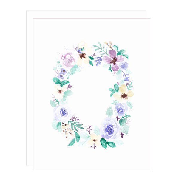 Notecard with a watercolor painting of garden flowers in blues, purples and cream with greenery in  a wreath shape