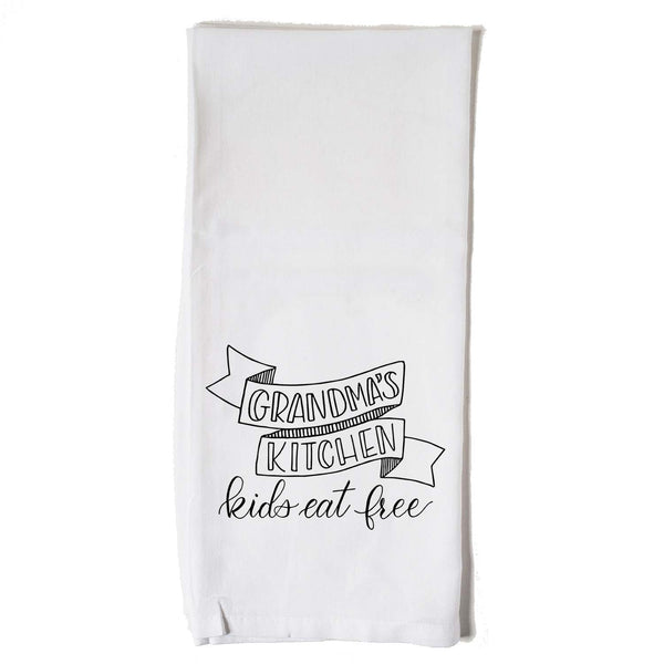White floursack kitchen towel with black hand lettered illustration that says grandma's kitchen kids eat free