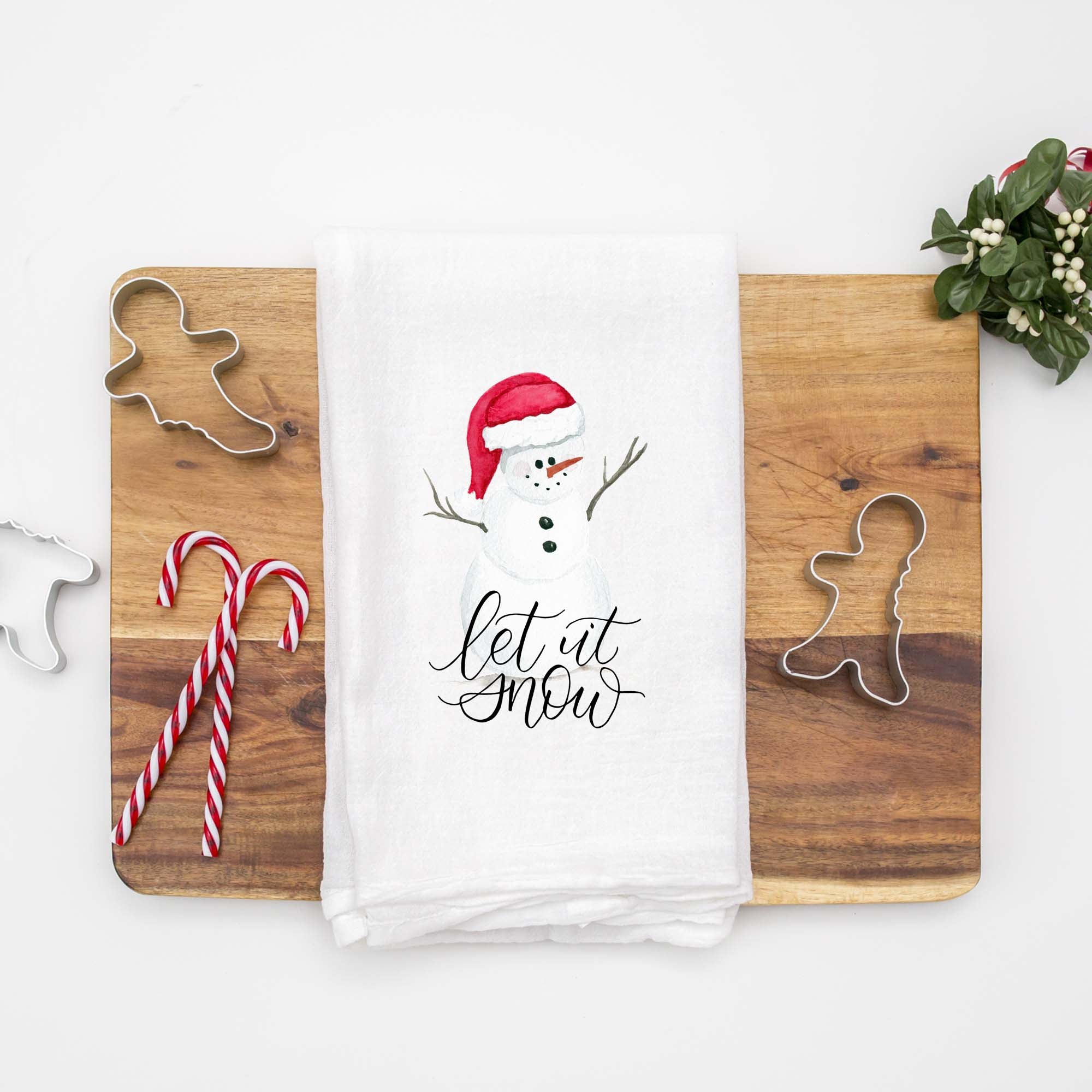 Floursack Kitchen Tea Towel with a watercolor painted snowman with a red santa hat that says let it snow