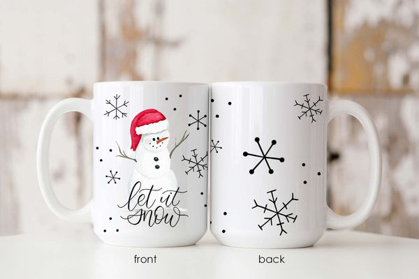 15oz white ceramic mug with watercolor snowman with a red santa hat, snowflake doodles and says let it snow in calligraphy showing front and back of mug