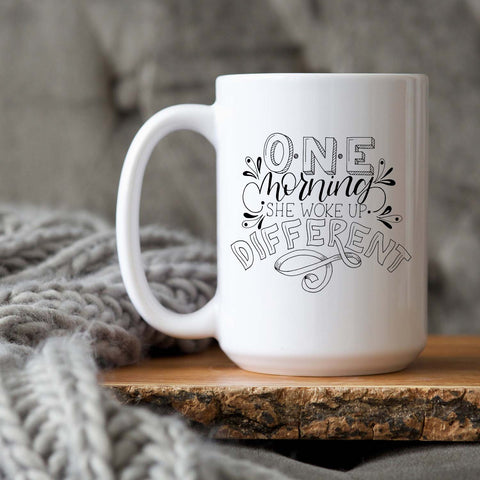 15oz white ceramic mug with hand lettered illustrated design that says I will become all that I was created to be shown on wood tray with a grey knit blanket