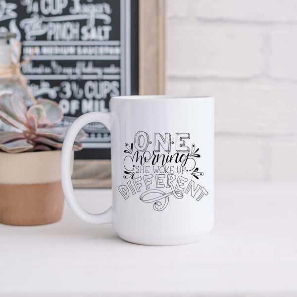 15oz white ceramic mug with hand lettered illustrated design that says I will become all that I was created to be shown in a kitchen