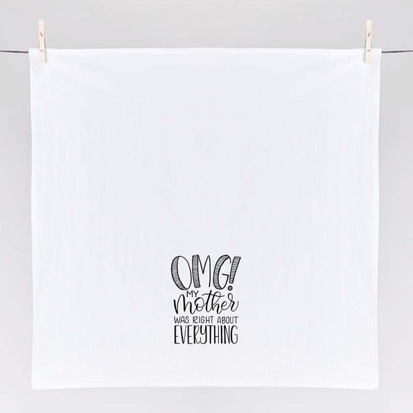 White floursack kitchen towel with black hand lettered illustrated design that says OMG! My mother was right about everything shown unfolded and hanging from clothes pins