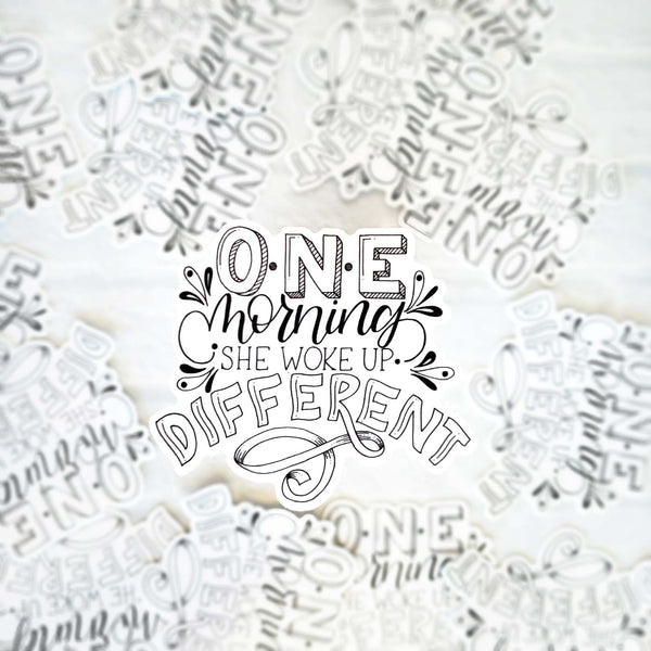 3" hand lettered, illustrated, black and white vinyl sticker that says one morning she woke up different