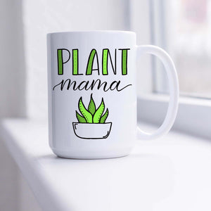 15oz white ceramic mug with hand lettered illustrated design that says Plant mama with the illustration of a succulent with green leaves shown sitting in a sunny window