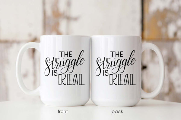 15oz white ceramic mug with hand lettered illustrated design that says the struggle is real showing both front and back of the mug