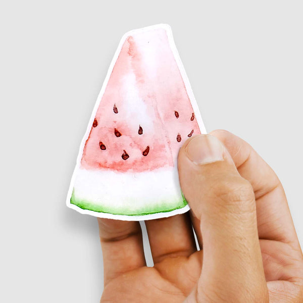 3" vinyl sticker of a watercolor painted slice of watermelon shown with a woman's hand holding the sticker