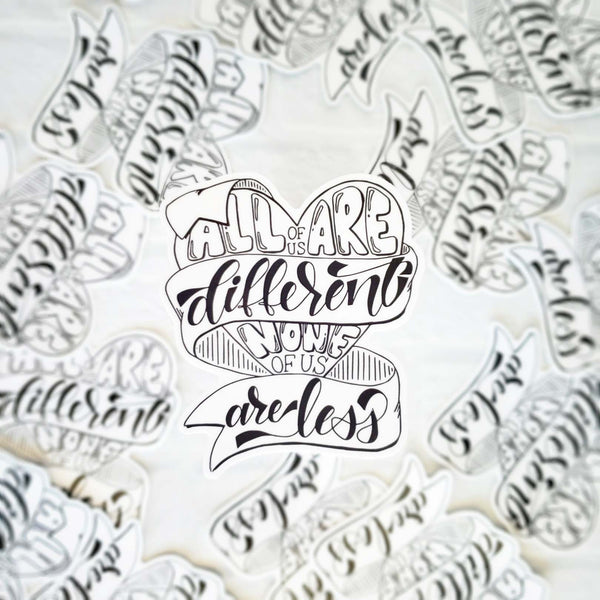 3" hand lettered, illustrated, black and white vinyl sticker saying all of us are different none of us are less