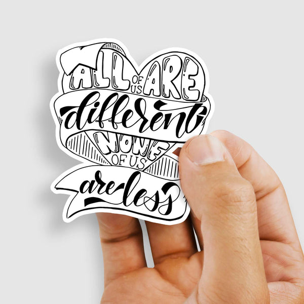 3" hand lettered, illustrated, black and white vinyl sticker saying all of us are different none of us are less shown with a woman's hand holding the sticker