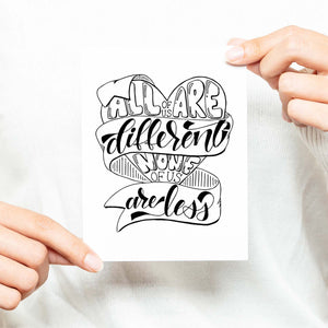 all of us are different none of us are less hand lettered and illustrated black and white on a white folded greeting card with A2 envelope shown with a woman in a white sweater holding card