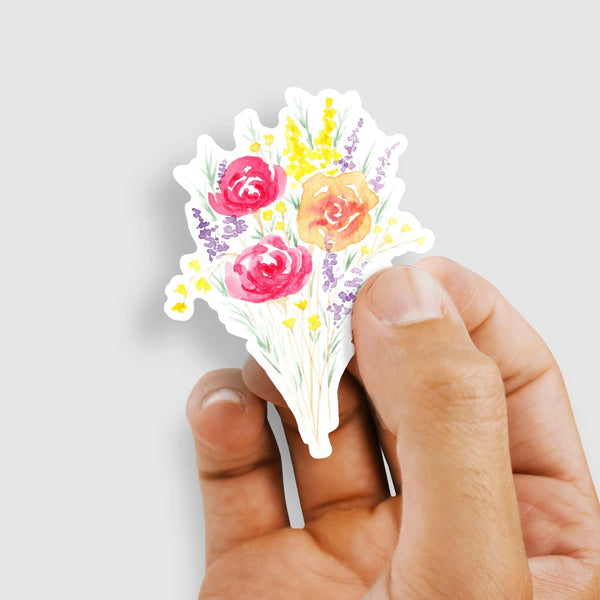 3" vinyl sticker of a watercolor bouquet of summertime wildflowers shown with a woman's hand holding the sticker
