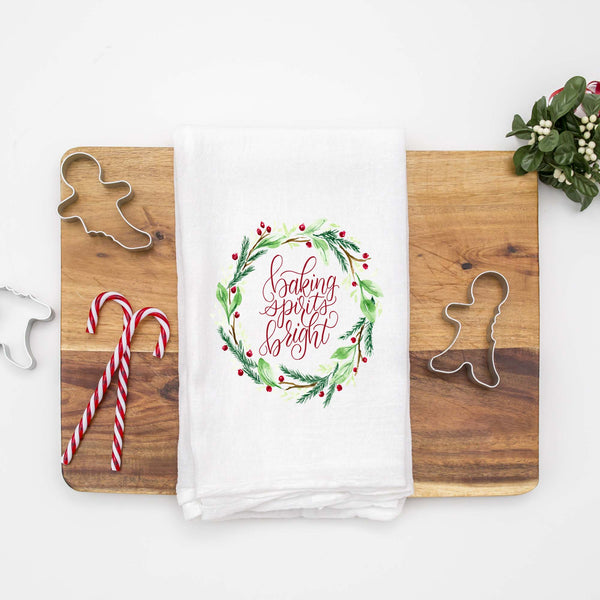 Floursack Kitchen Tea Towel with christmas watercolor wreath that says baking spirits bright