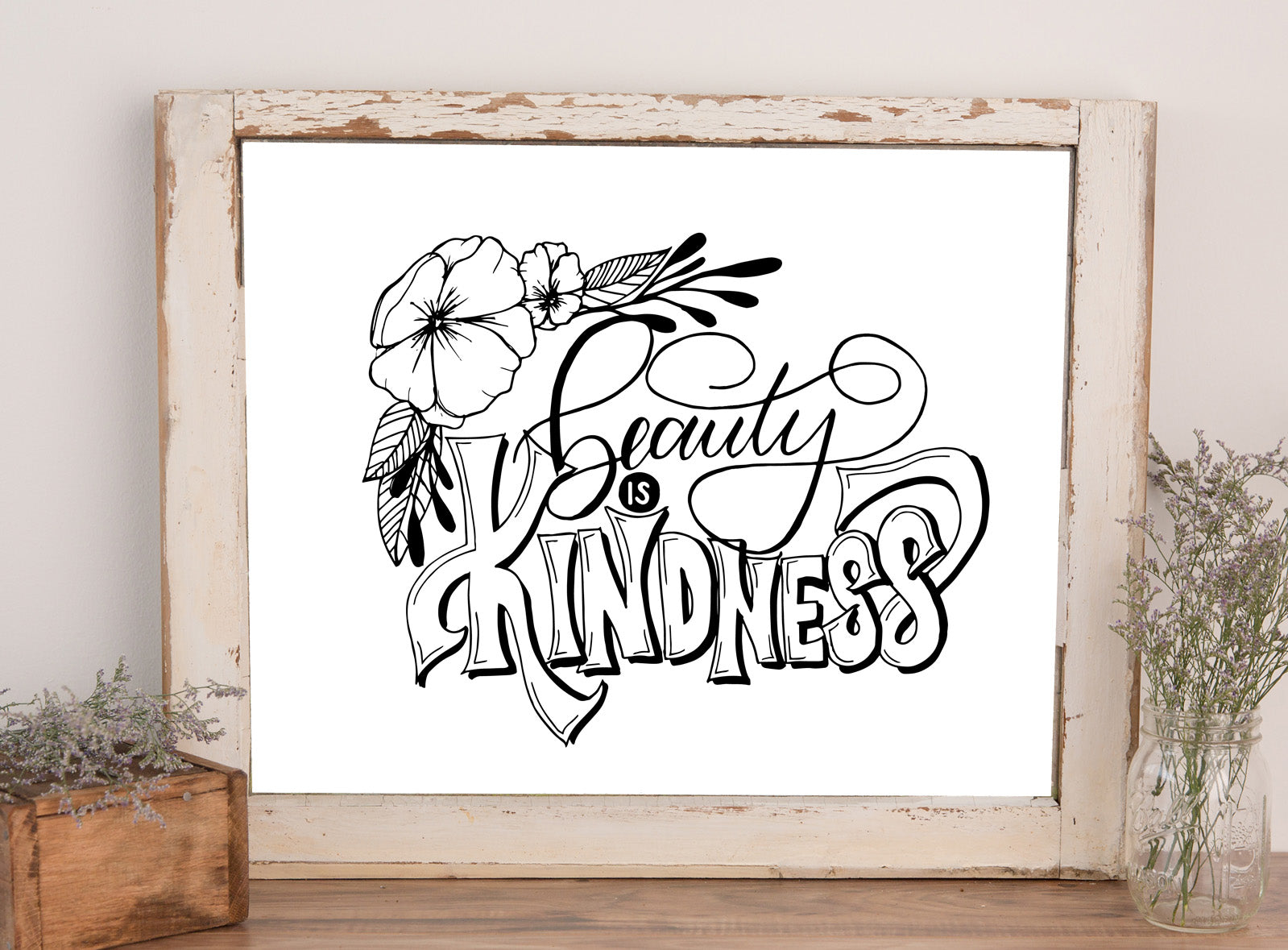 wall art that says beauty is kindness with floral illustrations in black and white