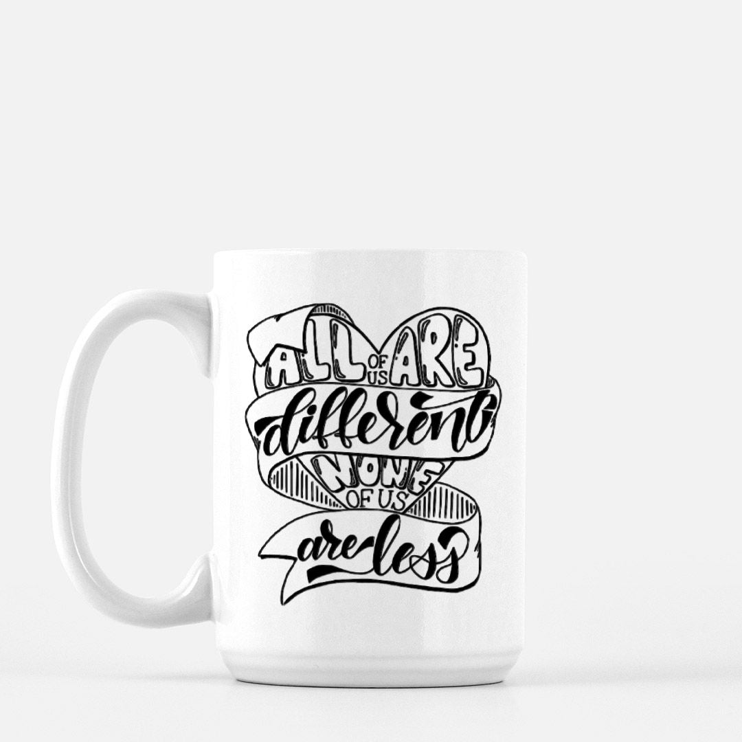 15oz white ceramic mug with hand lettered illustrated design that says all of us are different none of us are less