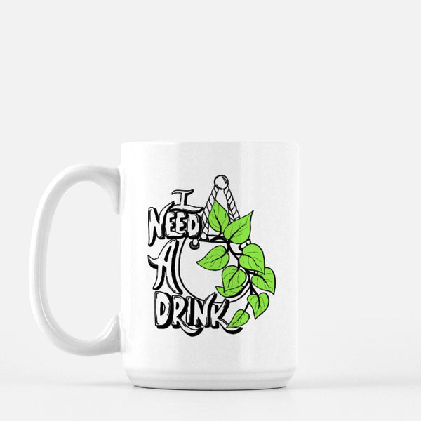 15oz white ceramic mug with hand lettered illustrated design that says I need a drink with an illustration of a pothos plant with green leaves in a hanging pot