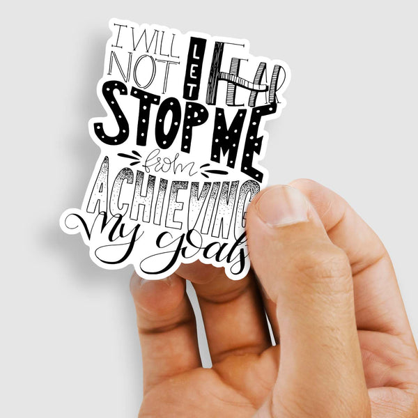 3" hand lettered, illustrated, black and white vinyl sticker saying I will not let fear stop me from achieving my goals shown with a woman's hand holding the sticker